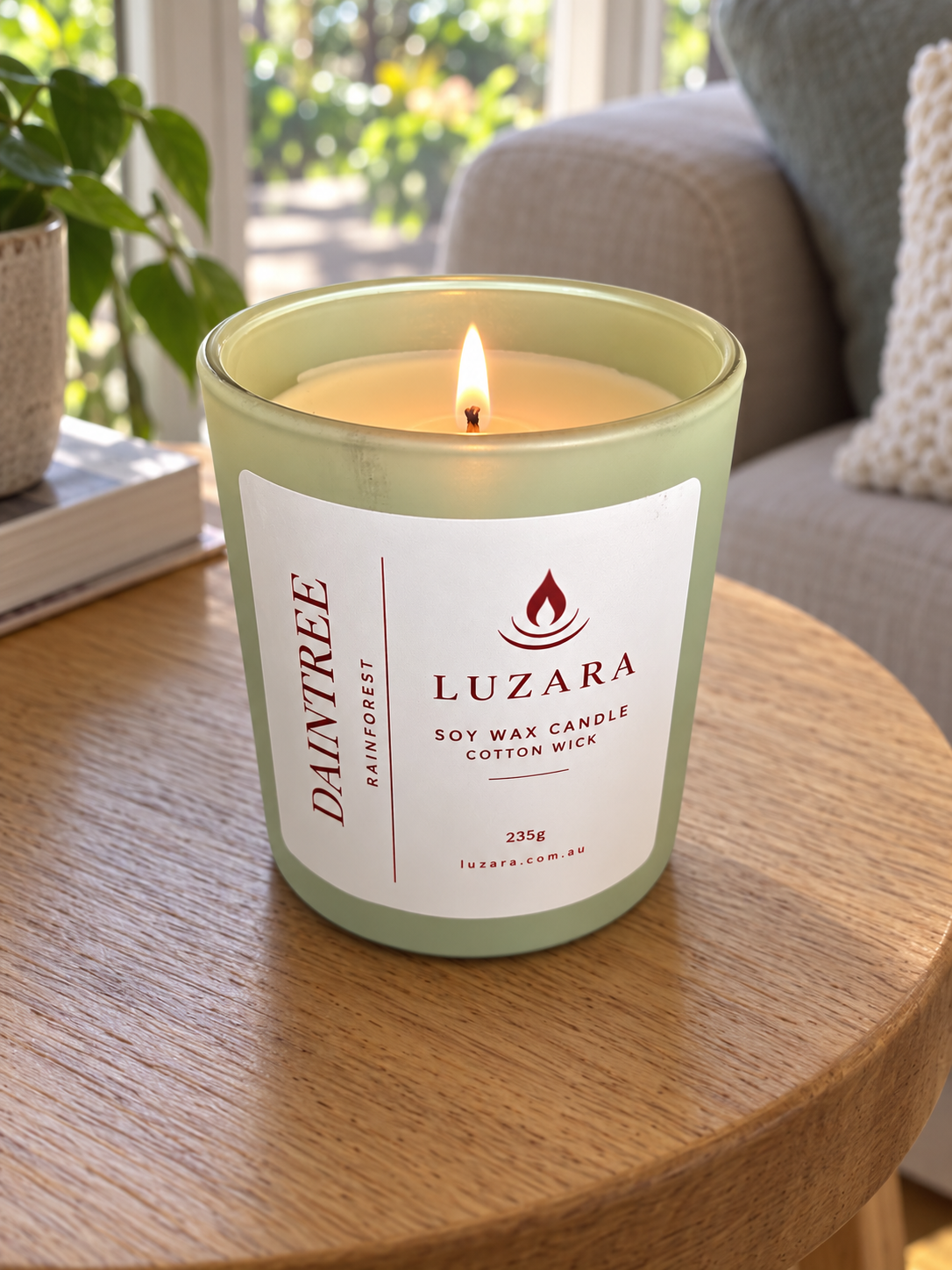 Daintree soy candle by Luzara lit with a cotton wick